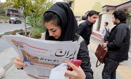Iranian girl reading newspaper