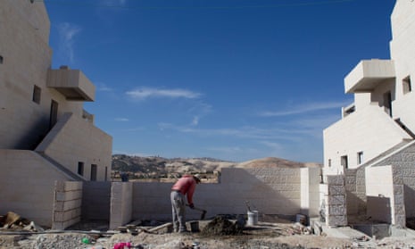 A man works at a new housing development in the Jewish West Bank settlement of Maaleh Adumim, near Jerusalem.