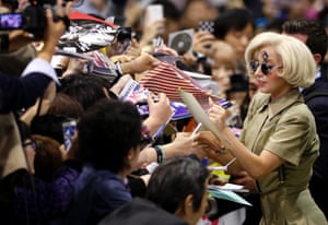 Lady Gaga signs autographs for fans at Narita international airport, Japan.