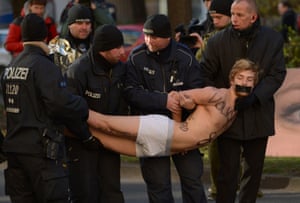 A demonstrator calling for the introduction of a nationwide referendum is arrested by police officers before coalition talks between the CDU/CSU and SPD in Berlin.