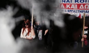 Employees from the Greek National Organisation for Healthcare carry a banner during a rally in central Athens.