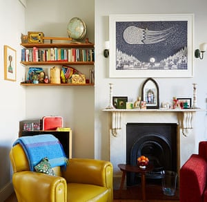 homes bold colourful lounge with yellow armchair and cast iron fireplace