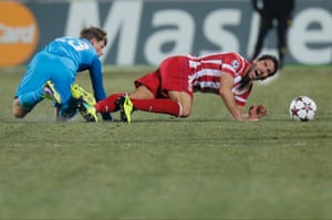 Zenit's Andrey Arshavin (L) fouls Atletico's Raul Garcia during the Champions League group G soccer match between Zenit and Atletico Madrid at Petrovsky stadium in St.Petersburg, Russia.