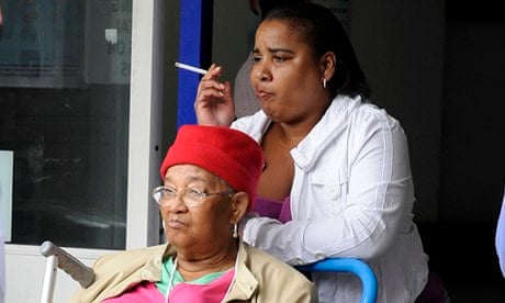 A visitor smokes in  entrance of a hospital 