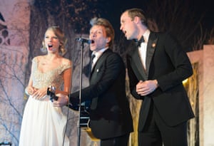 The Duke of Cambridge (R) sings with Taylor Swift (L) and Jon Bon Jovi at the Centrepoint Gala Dinner at Kensington Palace, London.
