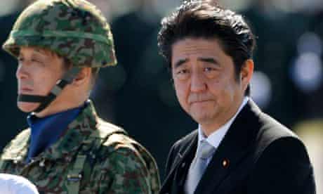 Japan's Prime Minister Shinzo Abe reviews Japan Self-Defence Forces troops in Asaka, Japan