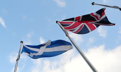 The Scottish saltire and the union flag fly side by side outside the Scottish Parliament. Science spending in Scotland may be threatened by English policy mistakes.