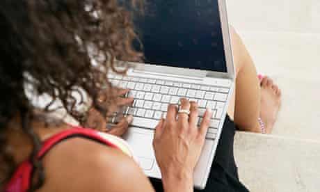 Young female typing on laptop at home