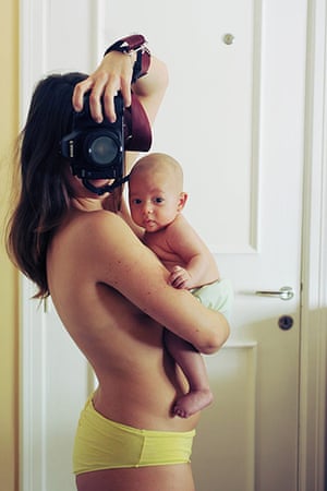 Big Picture - Pregnancy: semi-naked woman taking self-portrait with camera