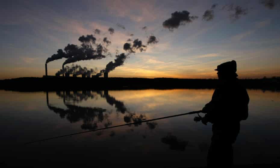 A man fishes in an artificial lake outside Belchatow Power Station, Europe's largest coal-fired power plant, October 31, 2013.