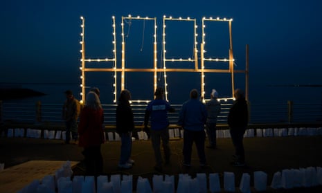 Residents look up at the word 'Hope' in lights during a community ceremony marking the one year anniversary of Hurricane Sandy in Union Beach, New Jersey, USA, 29 October 2013