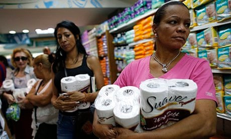 Women buy toilet paper at a supermarket in Caracas
