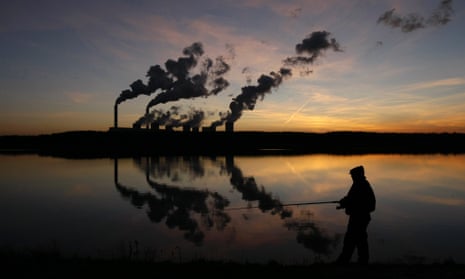 A man fishes in an artificial lake outside Belchatow Power Station, Europe's largest coal-fired power plant.