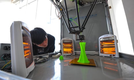 A technician watches a 3D-printing parallel robot at the Chinese Academy of Sciences.
