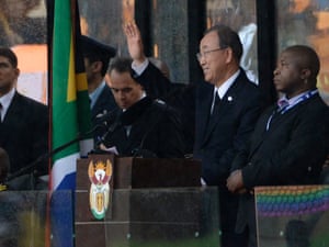 UN Secretary General Ban Ki-moon waves on stage as he attends the memorial service for Mandela