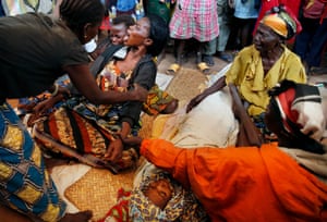 13 Dec: Diane Seresona is overwhelmed by grief as she sees the body of Prudence Seresona, 27, who just died from malaria at the makeshift camp for internally displaced people set up in the airport in Bangui