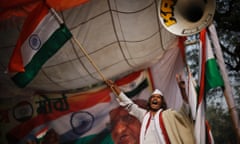 A supporter of social movement leader Anna Hazare waves the national flag as he celebrates the news of passing of the contentious anti-corruption bill.