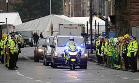 Rescue workers form a guard of honour for ambulances removing bodies from the Clutha bar 2/12/13 
