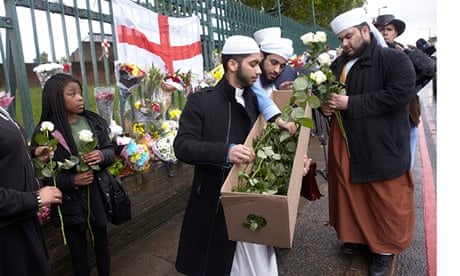 Members of the Muslim Council of Coventry hand flowers to fellow mourners after Lee Rigby's murder