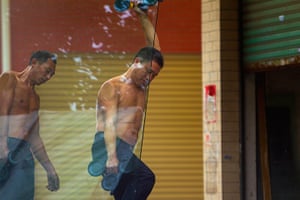 Weekend in pictures: Guangzhou, China: Shirtless workers carry a piece of glass in the cold weat