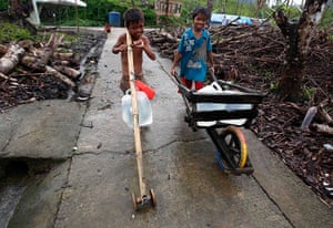 Weekend in pictures: Marabut, Philippines: Children who survived Typhoon Haiyan use improvised w
