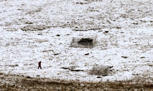 People walk their dogs in Pentland Hills on the outskirts of Edinburgh after snowfall.