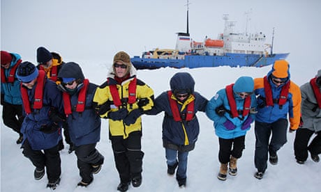 Scientists and passengers from the Akademik Shokalskiy stomp flat an area of ice