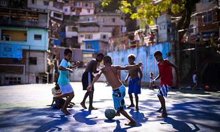 Boys play football in the Borel favela