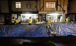 Weather UK: A make-shift flood barrier runs along the high street of Sandwich in Kent,
