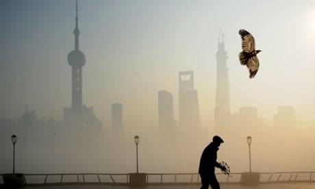 A man flies kite at The Bund on December 5, 2013 in Shanghai, China. Heavy smog continued to hit northern and eastern parts of China on Thursday, disturbing the traffic, worsening air pollution and forcing the closure of schools.