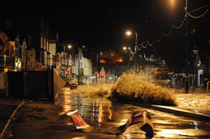 UK weather : Debris litters the road after the tidal surge stuck Scarborough