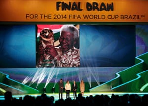 Brazilian President Dilma Rousseff (2nd L), FIFA President Sepp Blatter (2nd R), actor Rodrigo Hilbert and model Fernanda Lima stand on stage as a tribute to former South African President Nelson Mandela is shown on the screen during the draw for the 2014 World Cup at the Costa do Sauipe resort in Sao Joao da Mata, Bahia state, December 6, 2013. The 2014 World Cup finals will be held in Brazil from June 12 through July 13.
