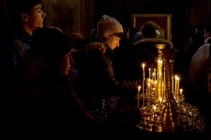 Ukrainian protests woman lights candles at the Mikhailovsky Cathedral 