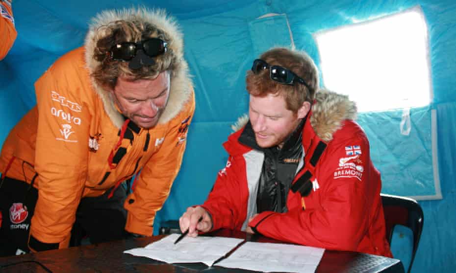 Prince Harry with a team member before the suspension of the race.