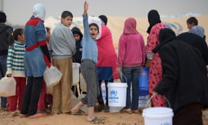Syrian refugees fetch water at Zaatari refugee camp in Jordan.