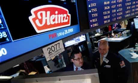 Traders work at the post that trades HJ Heinz Co on the floor of the New York Stock Exchange