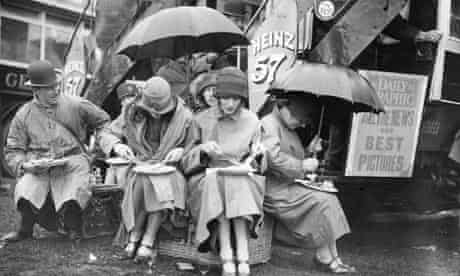 Epsom racegoers having lunch under umbrellas in the rain 1925