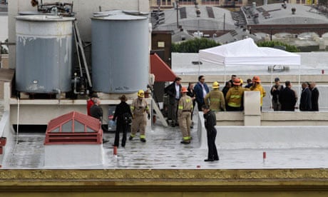 Authorities inspect a water tank atop the Cecil Hotel in downtown Los Angeles.