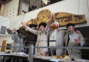 Ultra-Orthodox Jewish men and their rabbi (C) celebrate the Jewish holiday of Purim in Jerusalem's Mea Shearim neighbourhood. Purim, which will be marked next week, is a celebration of the Jews' salvation from genocide in ancient Persia, as recounted in the Book of Esther.