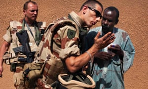 A French soldier talks with a local politician during a meeting in Gao, Mali.