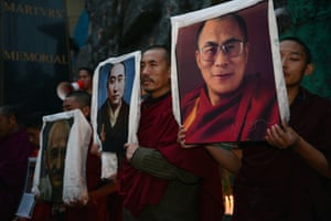 Exile Tibetans carry portraits of the Dalai Lama (R), the late Panchen Lama (C), and Indian independence icon Mahatma Gandhi (L) during a candlelight vigil to mourn the deaths of self-immolators in protest against Chinese rule in Tibet, in Dharamsala, India. Two Tibetans, identified as Tsezung Kyap, 27, and Sangdak, 19, reportedly self-immolated according to Tibetan rights groups. Photograph: Lobsang Wangyal/AFP/Getty Images