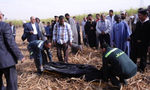 An ambulance crew lift the body of one of the tourists who died after a hot air balloon crashed in Luxor at dawn today.