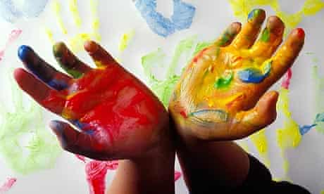 A pair of childrens hands with paint
