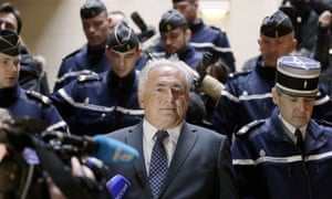A heavy police presence: Disgraced IMF chief Dominique Strauss-Kahn leaves a Paris courthouse after attending a hearing regarding his seizure request of the new book by Argentinian-born Marcela Lacub detailing their liaison.