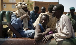 Prisoners are taken out of a jail at the gendarmerie in the northern Malian city of Gao on to be transferred on a military flight to Bamako, where they are to be judged on charges of belonging to the main Islamist armed group, the Movement for Oneness and Jihad in West Africa (MUJAO).