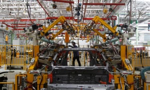 An employee works on a production line of Mahindra & Mahindra's vehicle manufacturing plant at Chakan, near Pune, India.