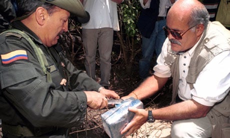 General Ernesto Gilibert, right, and Leo Arreguin, examine seized cocaine, Colombia in 2000