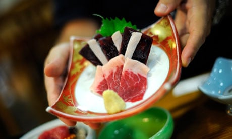 Whale meat sashimi is served with fresh ginger at a hotel in Taiji, Japan