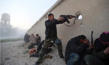 A Free Syrian Army fighter fires a rifle as he enters a Syrian Army base during heavy fighting in the Arabeen neighbourhood of Damascus 3 February 2013.