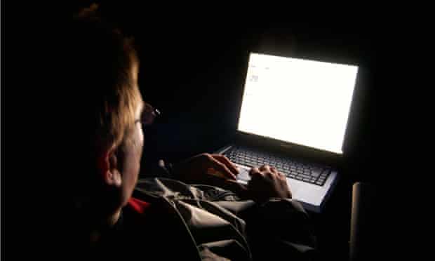 Man using computer at night.